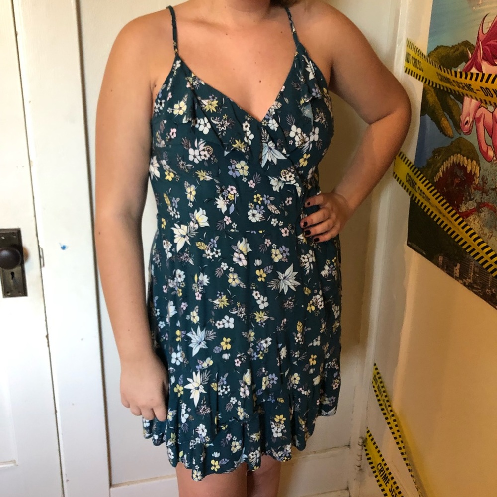 Dark teal razor back dress with a floral pattern